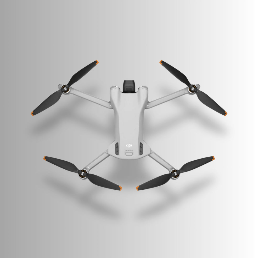 DJI Mini 3 drone with four propellers viewed from above, showcasing its compact and lightweight design.