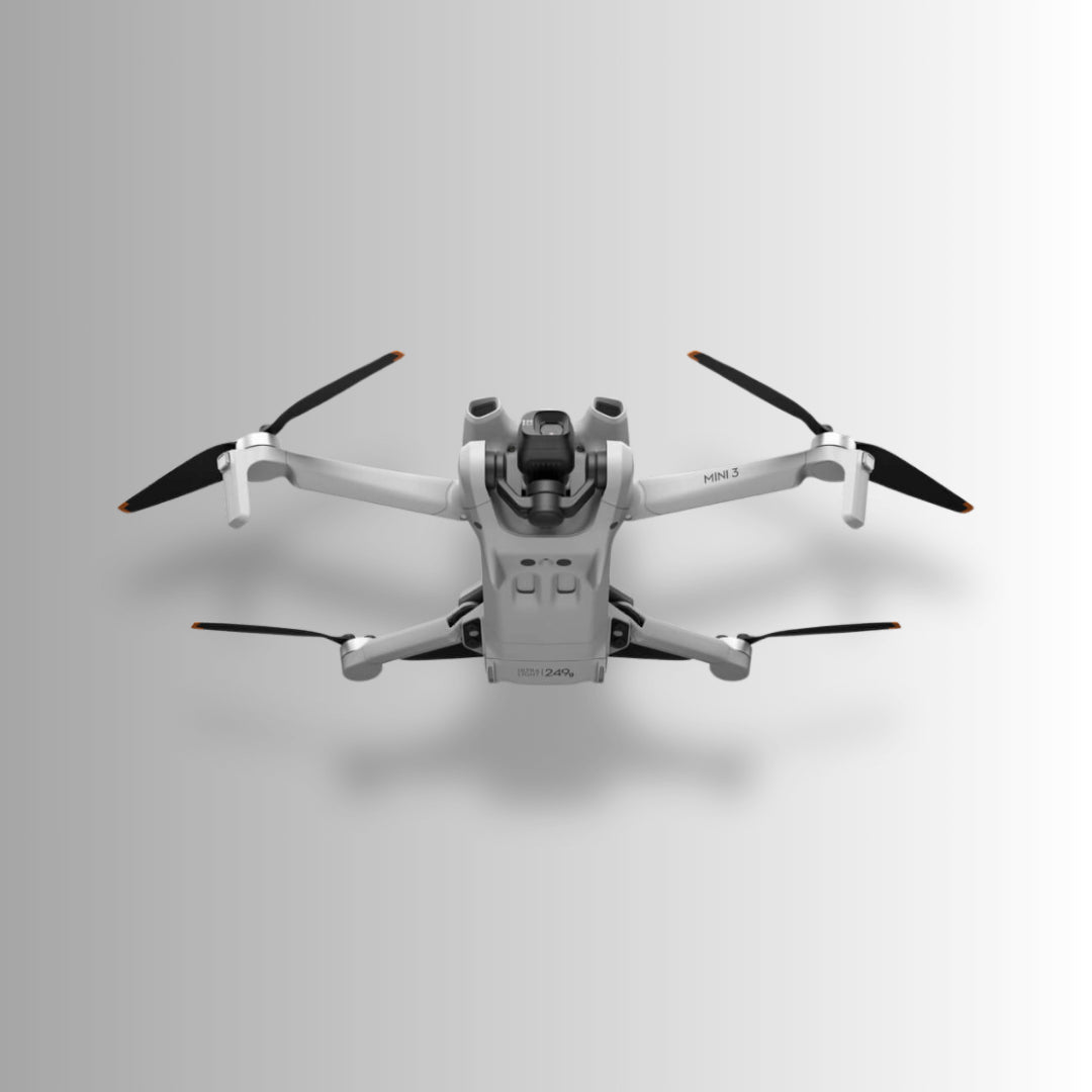 DJI Mini 3 drone flying overhead, showcasing its lightweight design and compact features for aerial photography.