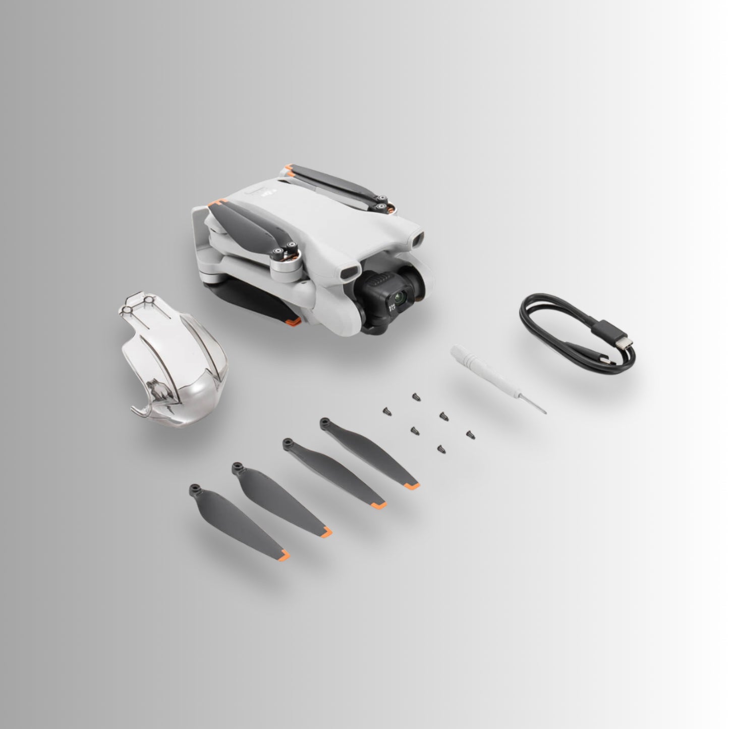 DJI Mini 3 drone and accessories including propellers and tools, designed for aerial photography.