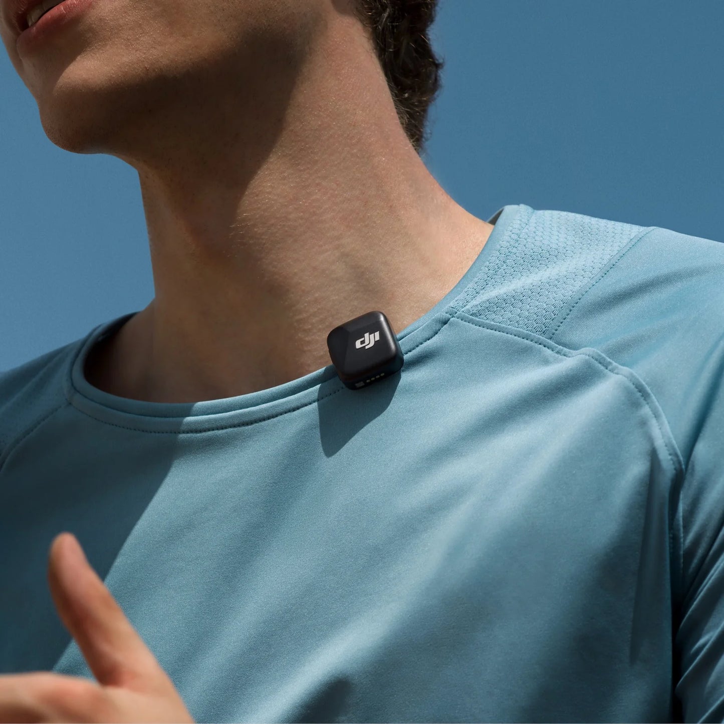 DJI Mic Mini wireless transmitter clipped to shirt for clear audio during outdoor vlogging or livestreaming