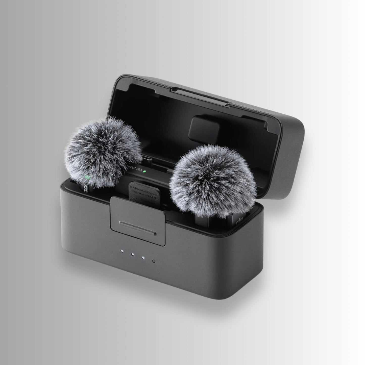 DJI Mic Mini transmitters with furry windshields placed in charging case for outdoor audio recording