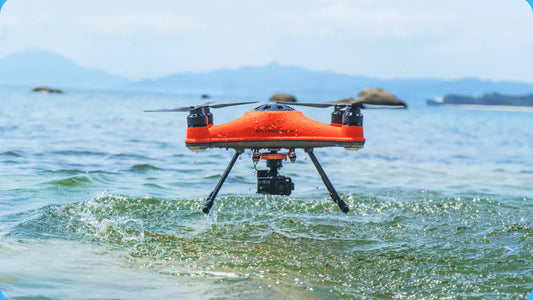 SwellPro SplashDrone 4+ flying on sea surface with mountains in the background