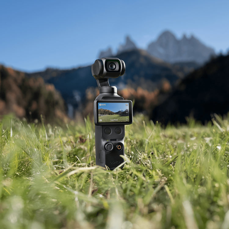 dji osmo pocket 4 sat on grass with mountains in the background