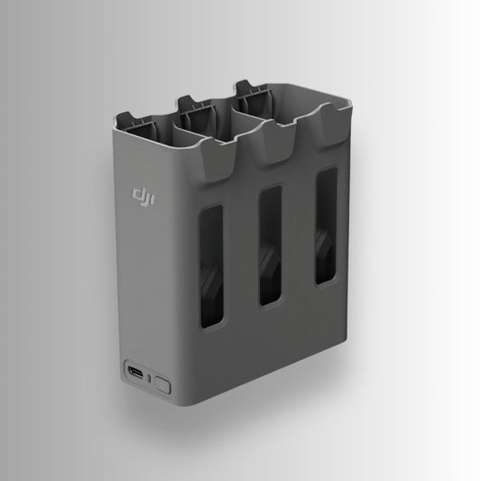 Grey two-way charging hub with multiple slots and a USB port for DJI Avata 360 on a white background
