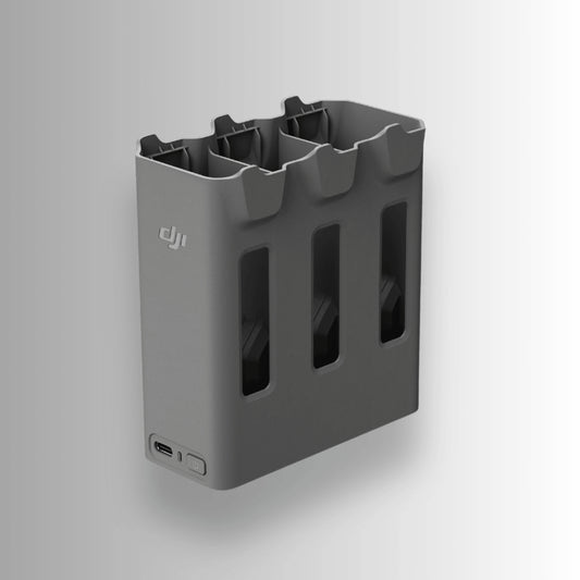 Grey two-way charging hub with multiple slots and a USB port for DJI Avata 360 on a white background