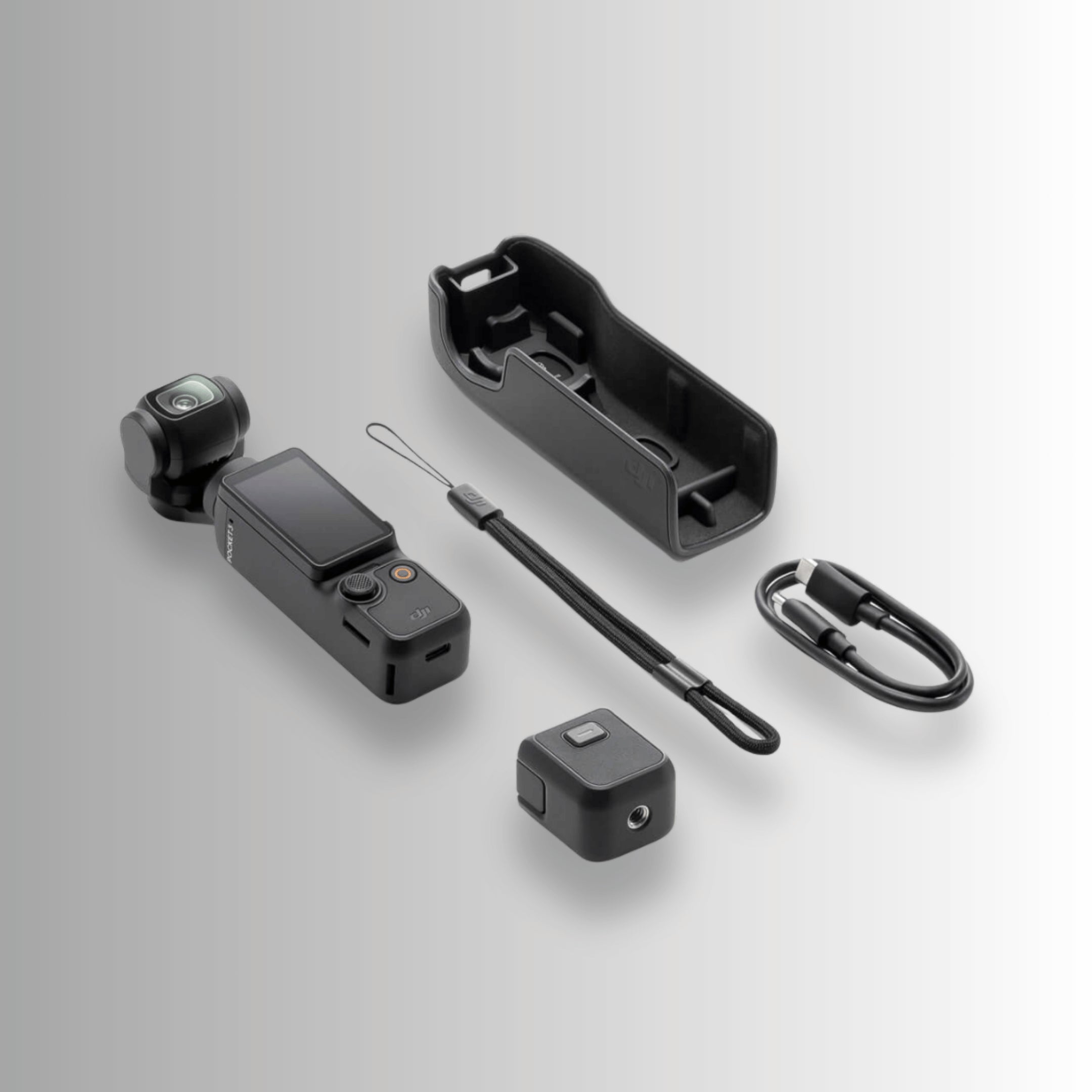 DJI Osmo Pocket 3 unboxed contents including camera, protective cover, wrist strap and USB-C cable