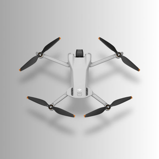 DJI Mini 3 drone with four propellers viewed from above, showcasing its compact and lightweight design.