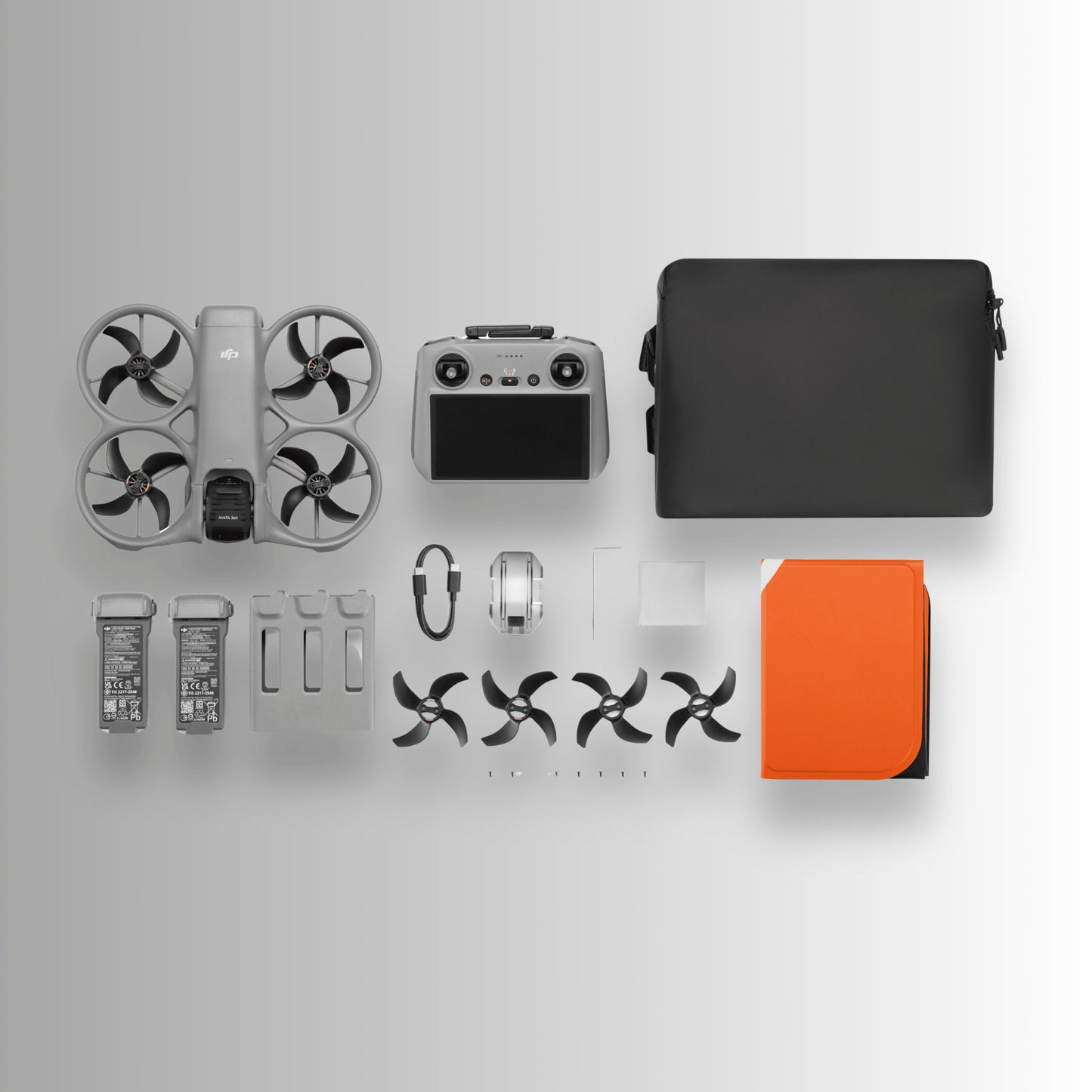 DJI Avata 360 Fly More Combo with drone parts and accessories on a light gray background