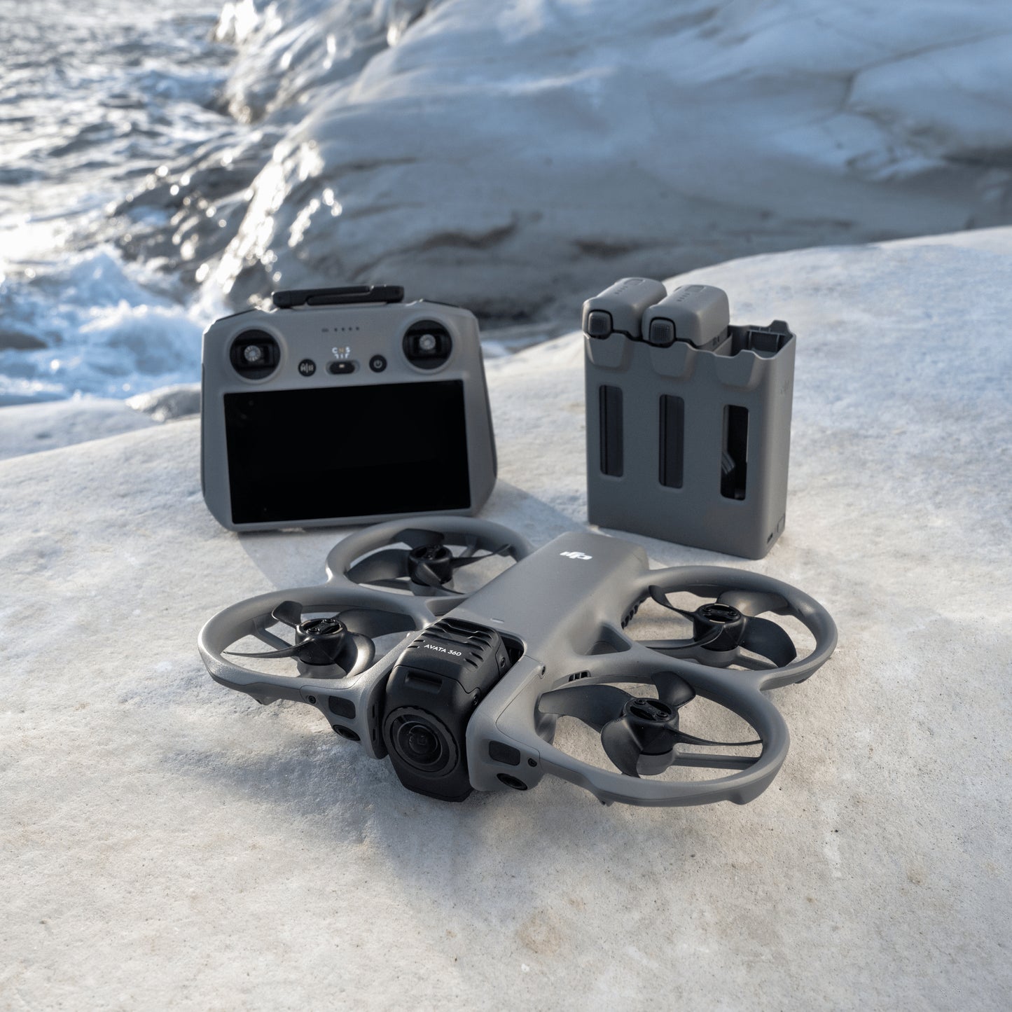 DJI Avata 360 fly more combo drone and RC 2 controller on a snowy surface