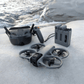 DJI Avata 360 motion fly more combo Drone and RC Motion 3 controller on a snowy surface with water in the background