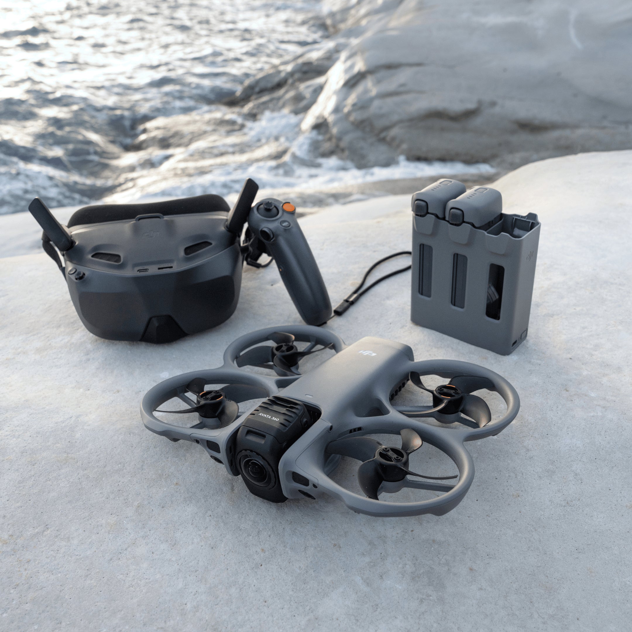 DJI Avata 360 motion fly more combo Drone and RC Motion 3 controller on a snowy surface with water in the background