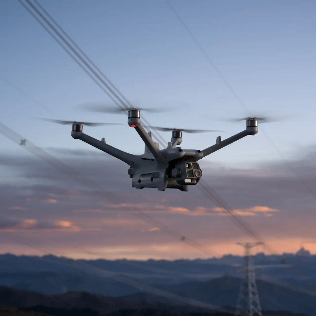 DJI Matrice 4TD enterprise drone flying underneath a power line