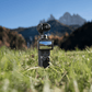 DJI Osmo Pocket 4 features showcased in a natural outdoor setting with mountains in the background.