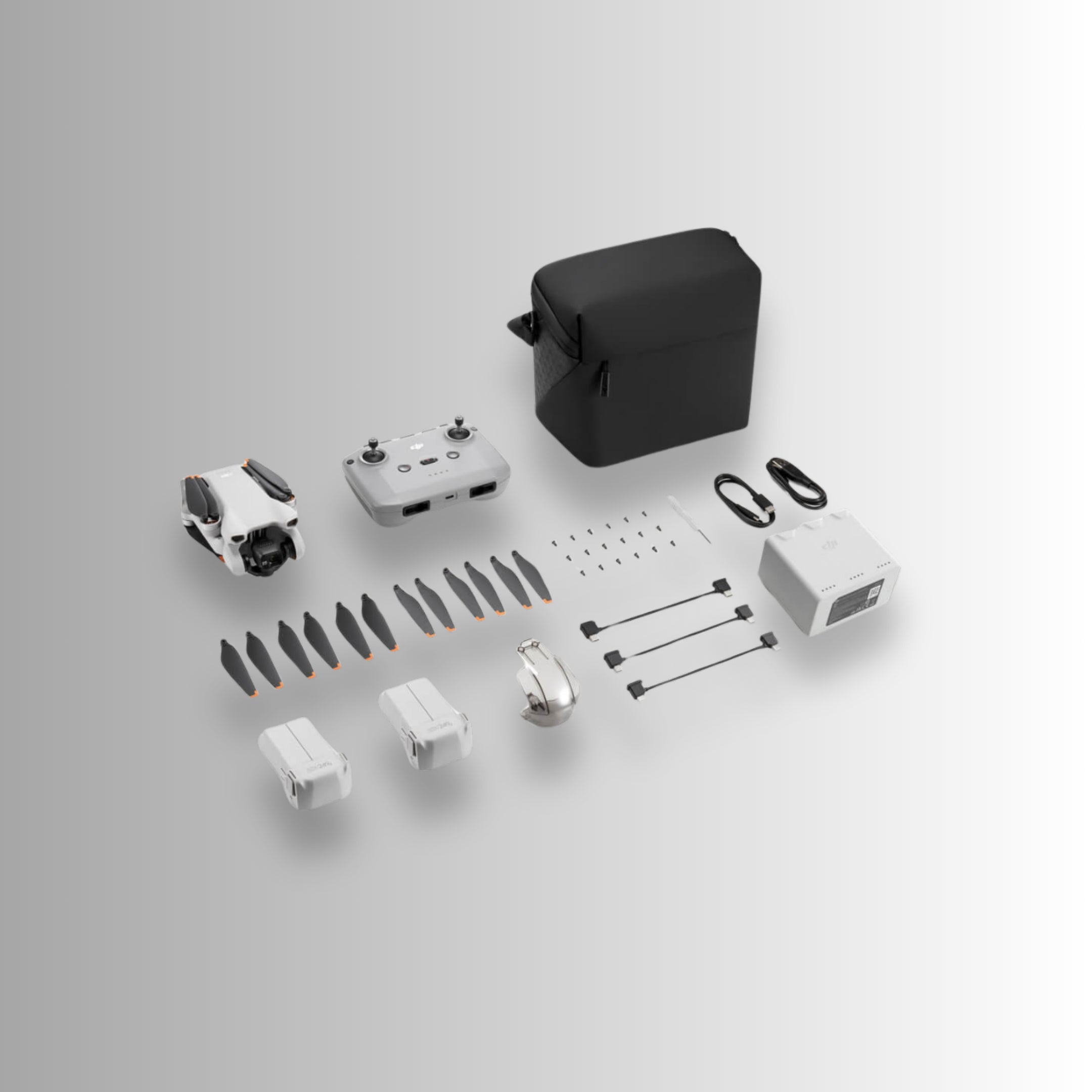 DJI Mini 3 Fly More Combo contents including drone, controller, propellers, battery, and charging accessories.
