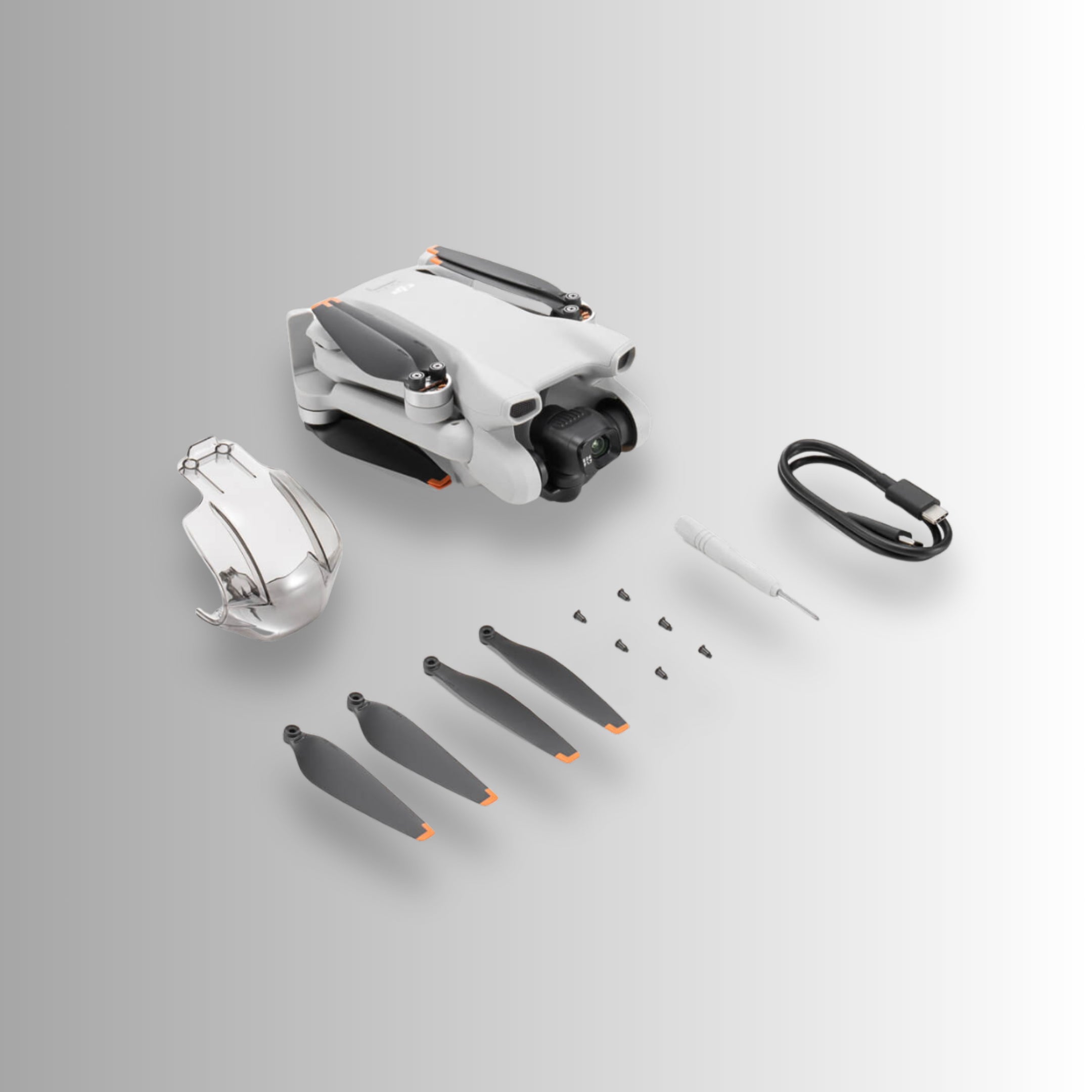 DJI Mini 3 drone and accessories including propellers and tools, designed for aerial photography.